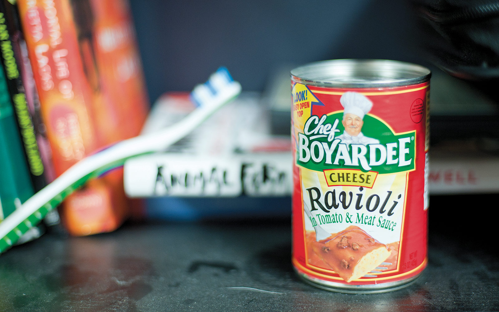 Here's a detail that you can find at most college campuses: the dusty residence hall shelf with random combinations of objects, like a toothbrush and some ravioli.