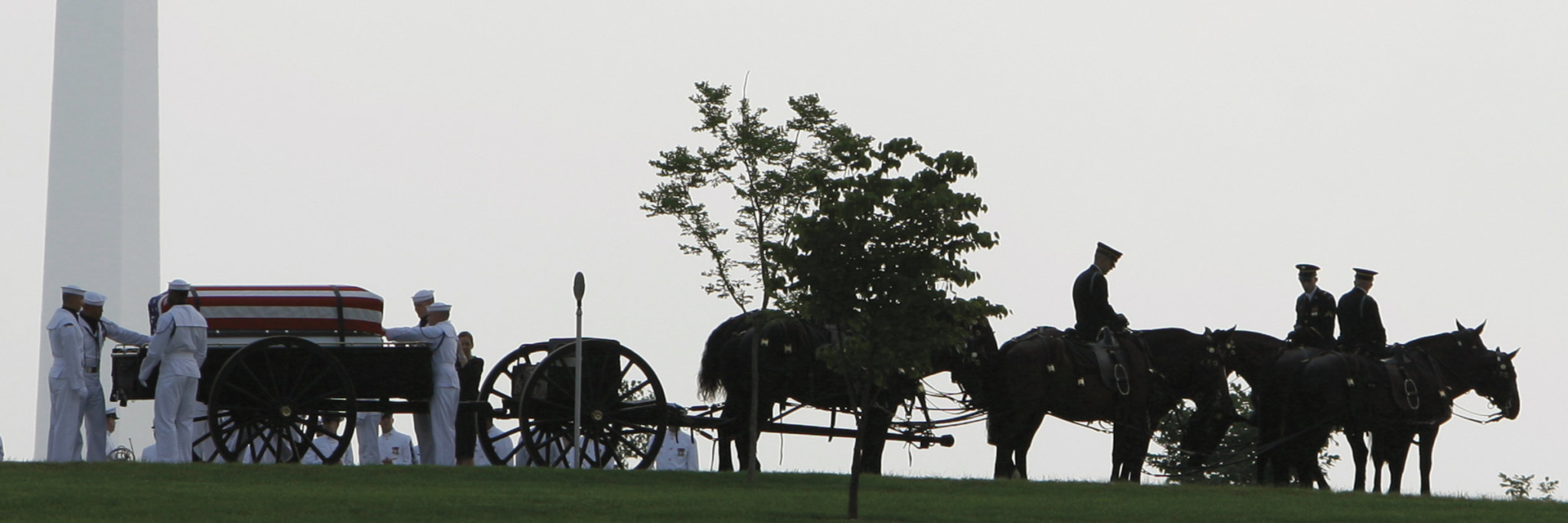 The remains of Commander Charles K. Springle, one of the five soldiers allegedly shot and killed by John Russell at Camp Liberty's combat stress clinic on May 11, are transported to Arlington National Cemetery in June 2009.