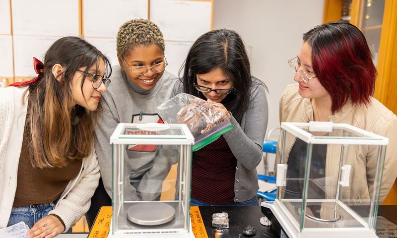 Assistant professor Anjali Fernandes with students in science lab.