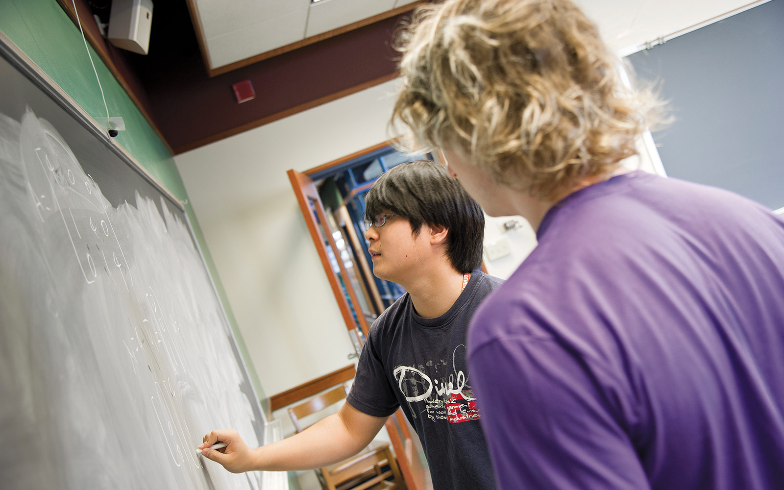 I found these guys working on a huge math equation during their lunch break. They said they just do this for fun. I looked at the equation, and of course it meant absolutely nothing to me. It was almost the length of the blackboard.