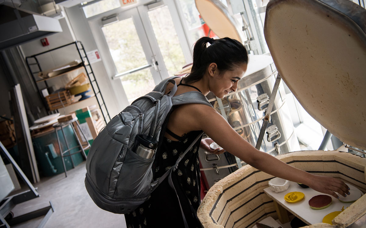 Student checking Kiln