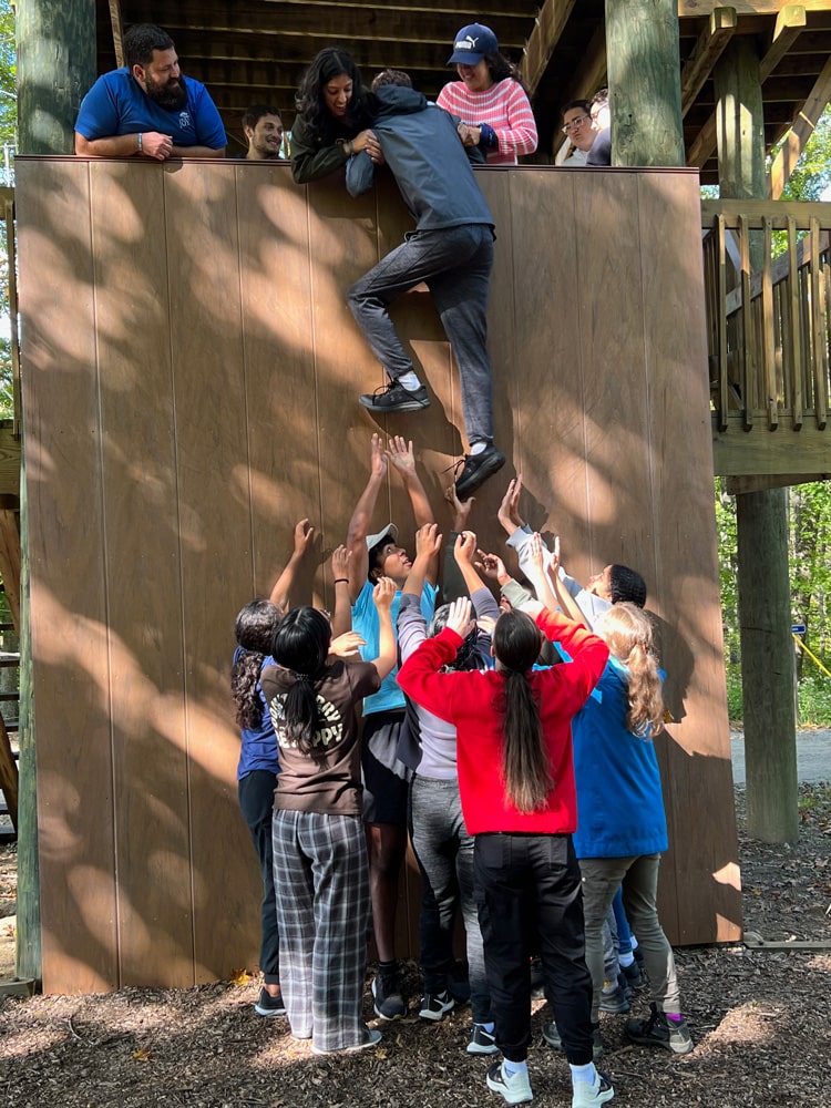 Students lifting each other up