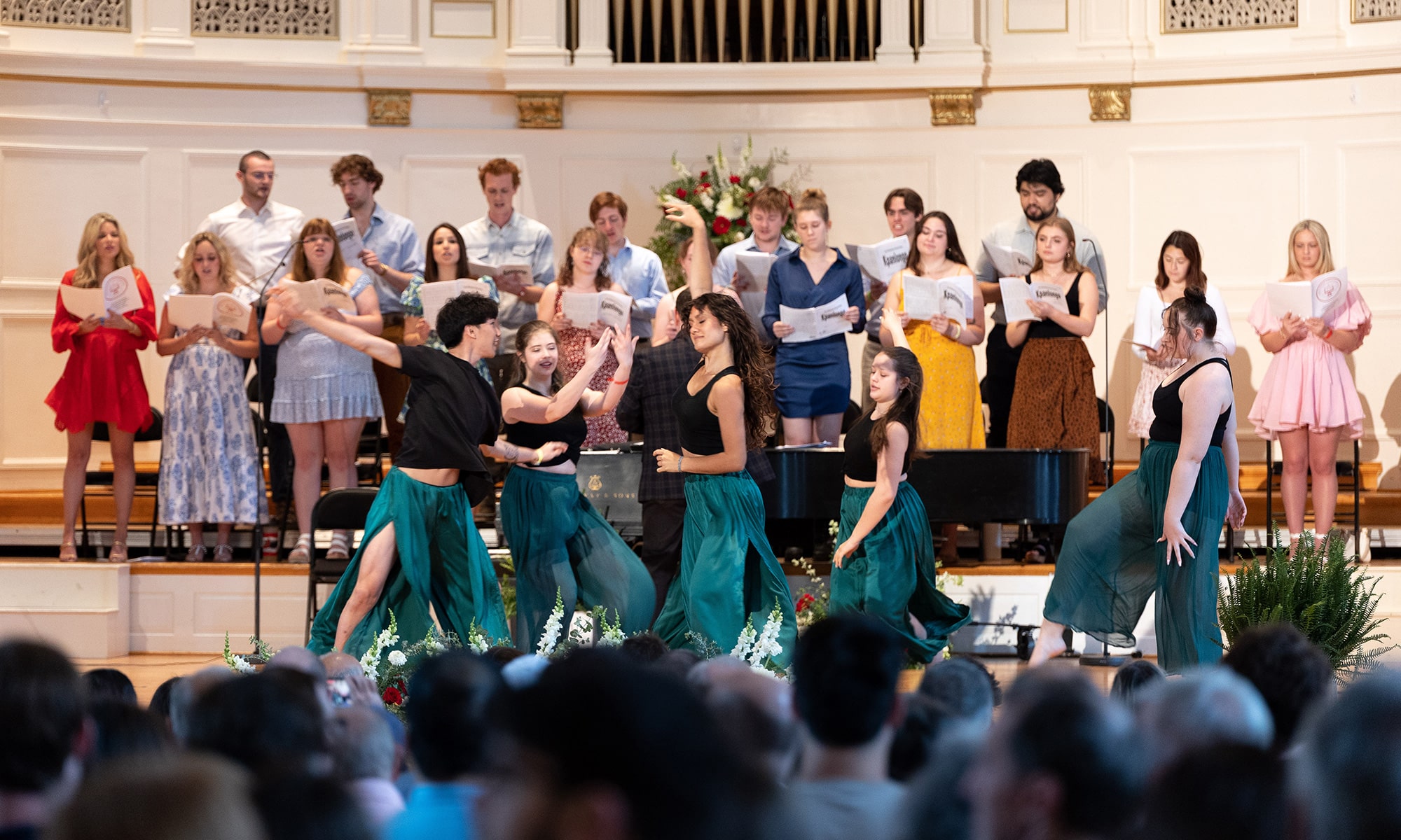 Baccalaureate Choir sings a West African folk song, while dancers perform on the stage