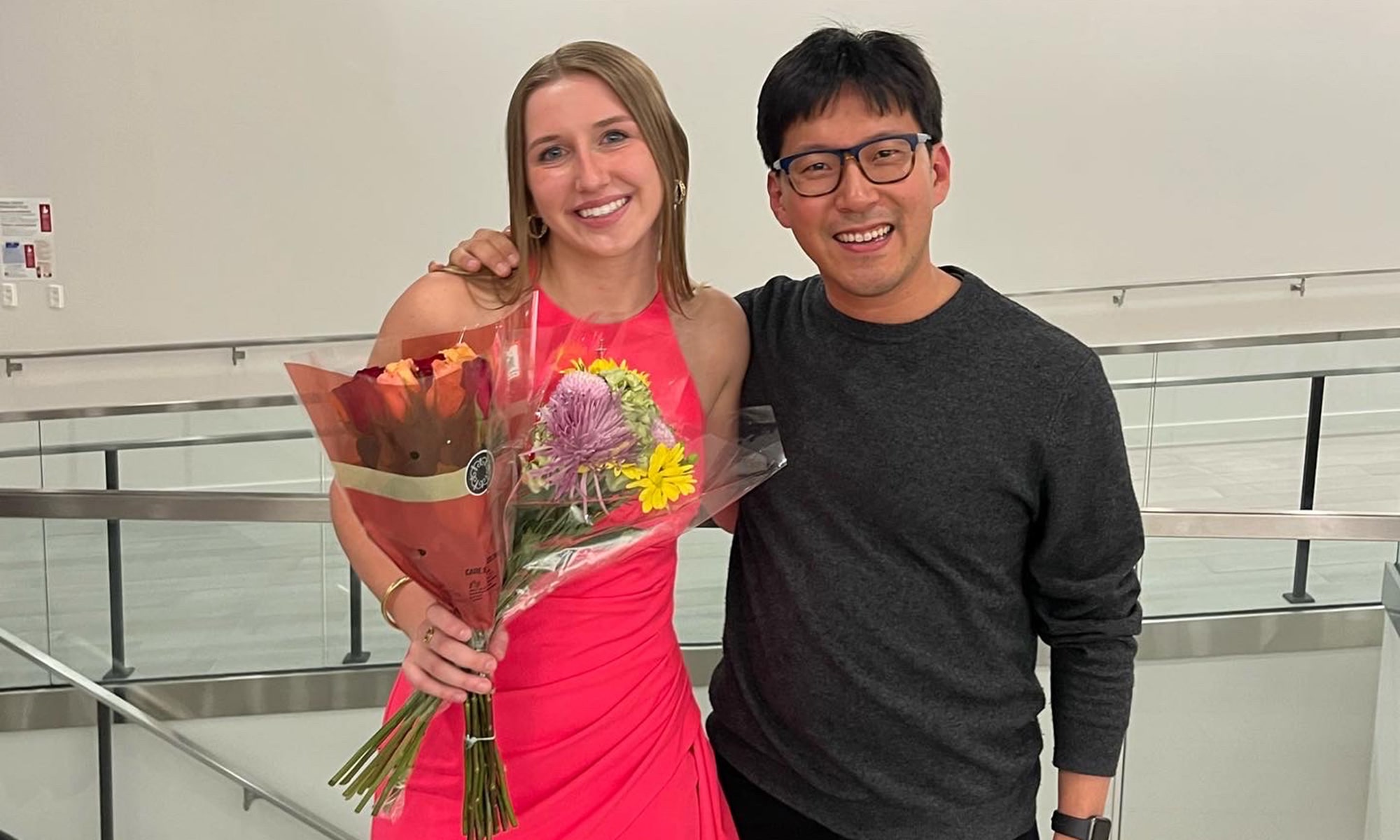 Ellie Blasko holding flowers with Sun Min Kim