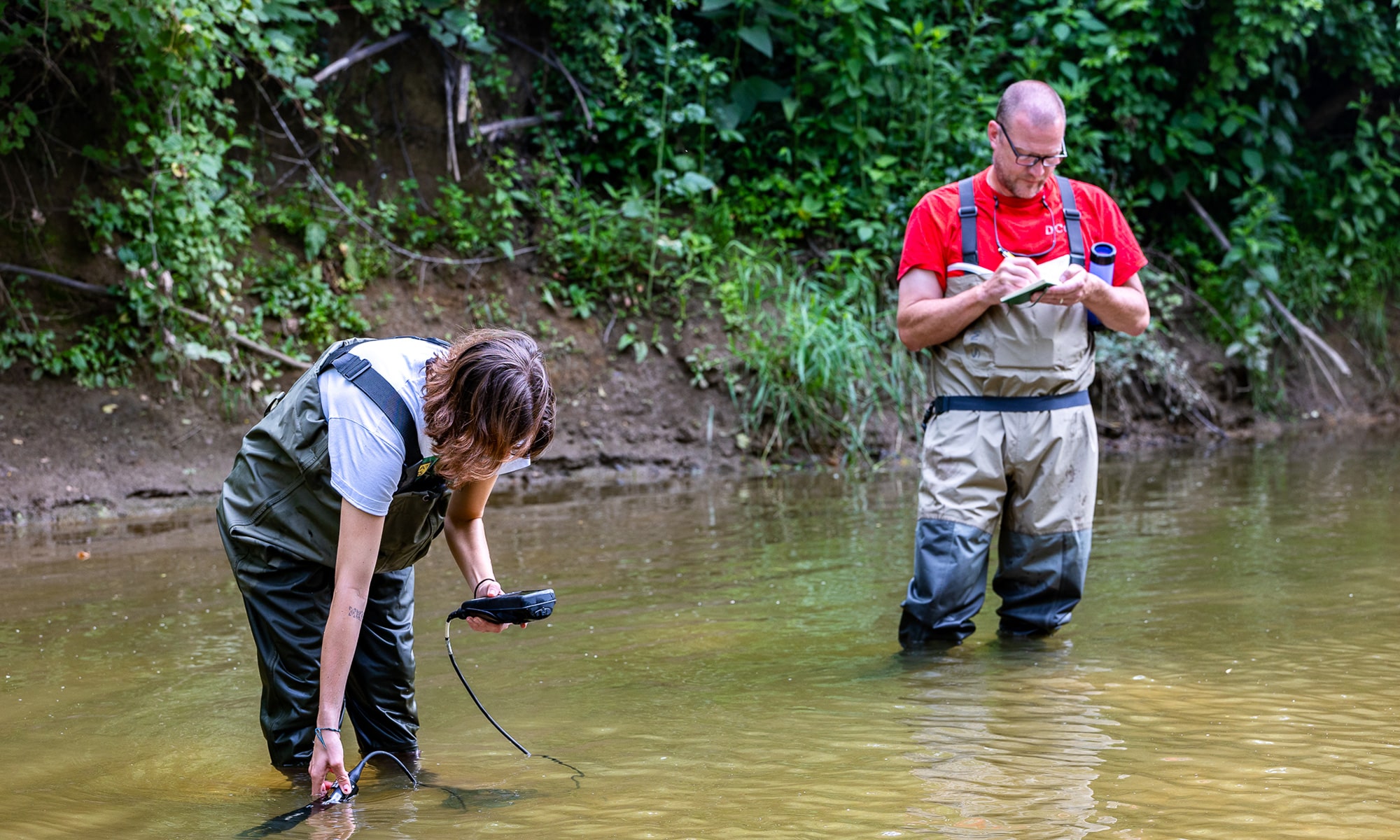 Caroline Lopez measures the water and Dave Goodwin makes notes