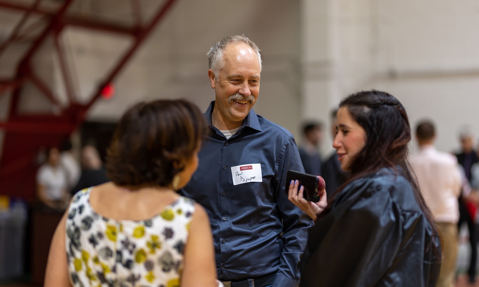 Associate Professor Paul Djupe talking to a graduate and their family