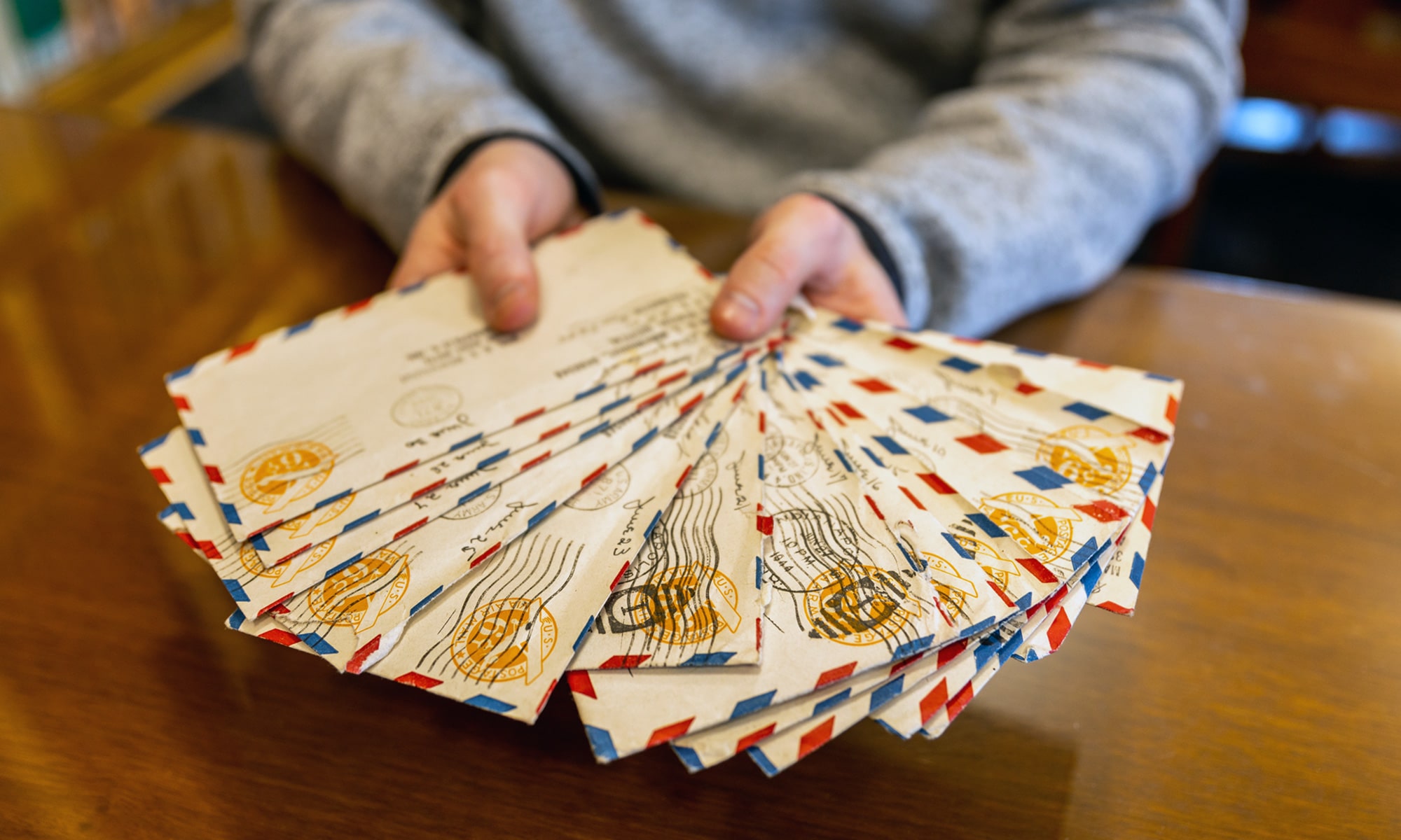 A person holding letters fanned out