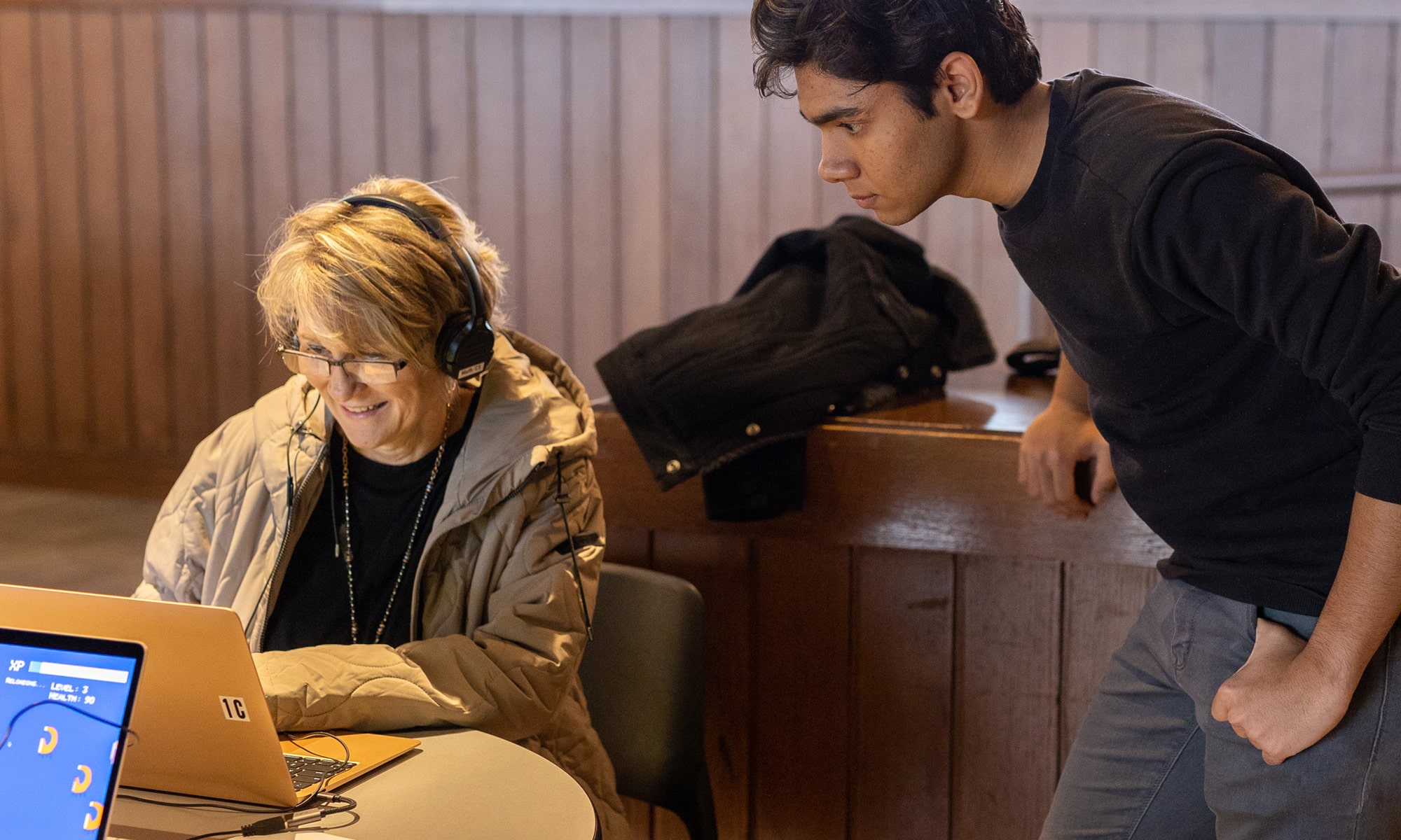 Provost Kim Coplin plays a game on a laptop