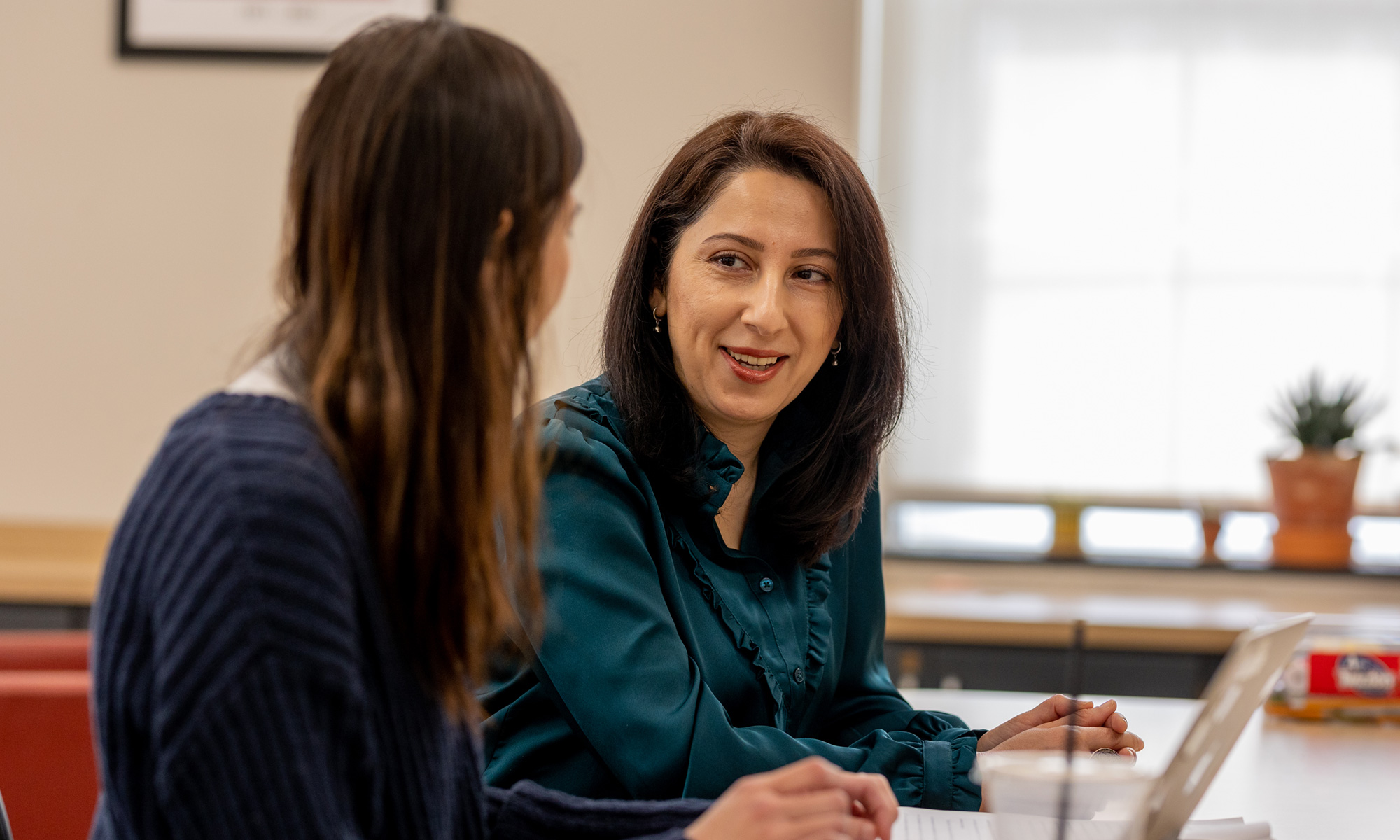 Zarrina Juraqulova in conversation with a student