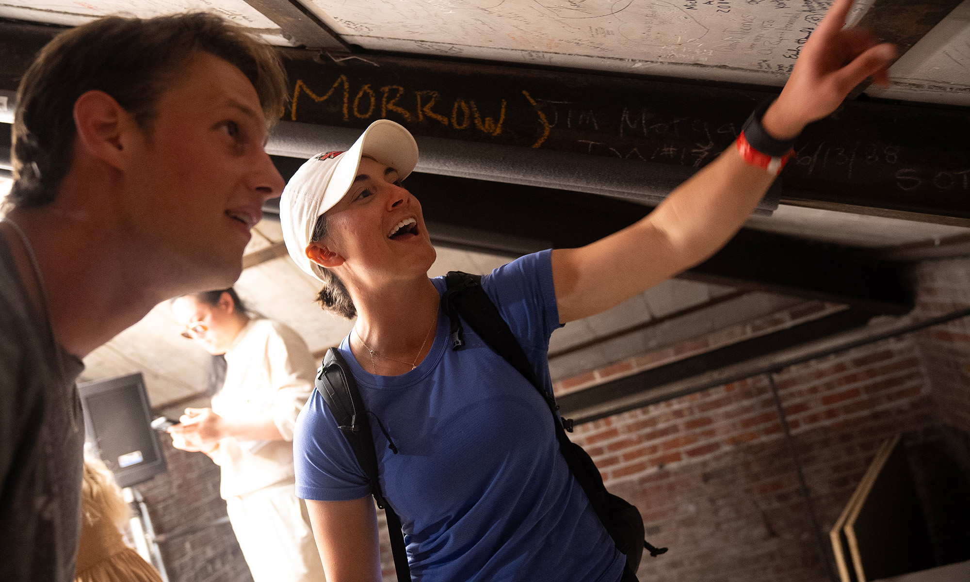 Jacob Brown and Kate Griffin look at the ceiling inside Swasey's bell tower operation room. 