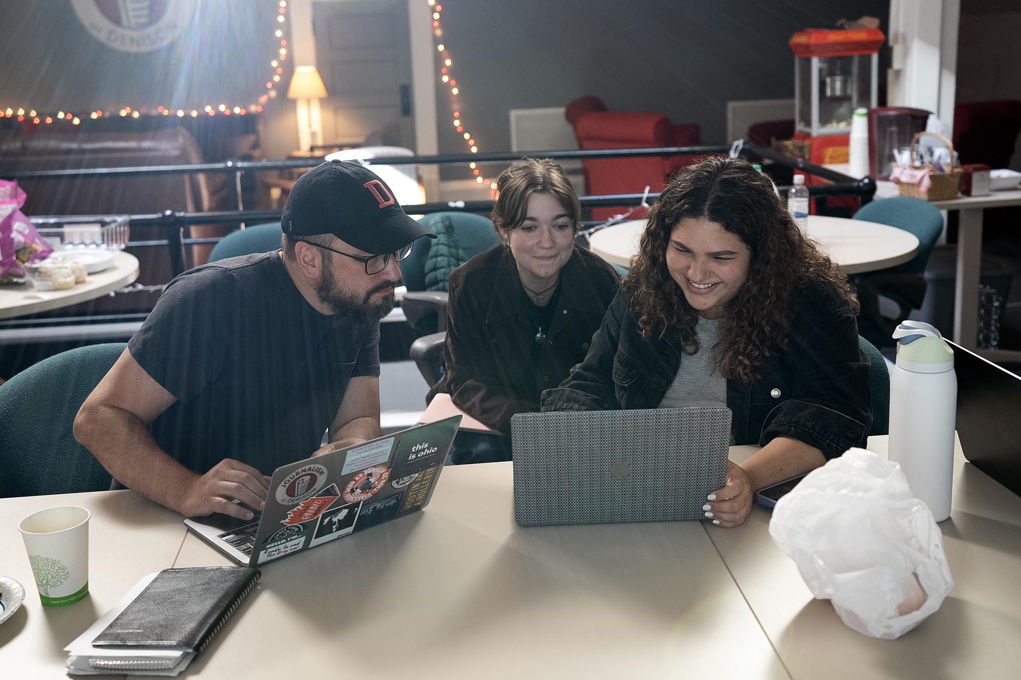 The Reporting Project staff members at a laptop discussing a story.