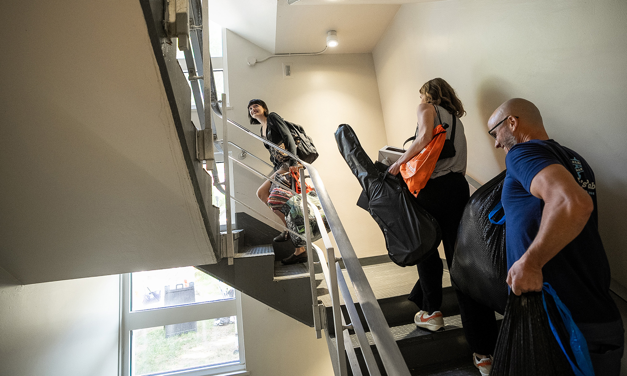 Families and students climb staircase