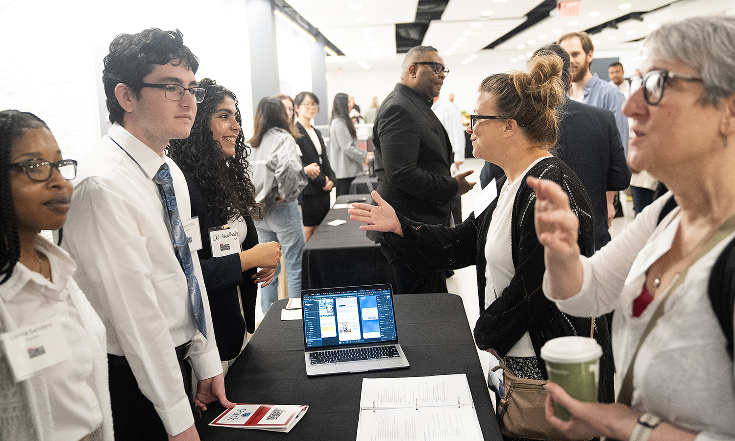 Students talk to patrons about their business ideas.