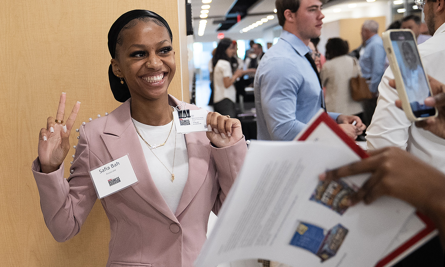 A student posing for a cell phone photo after a presentation. 