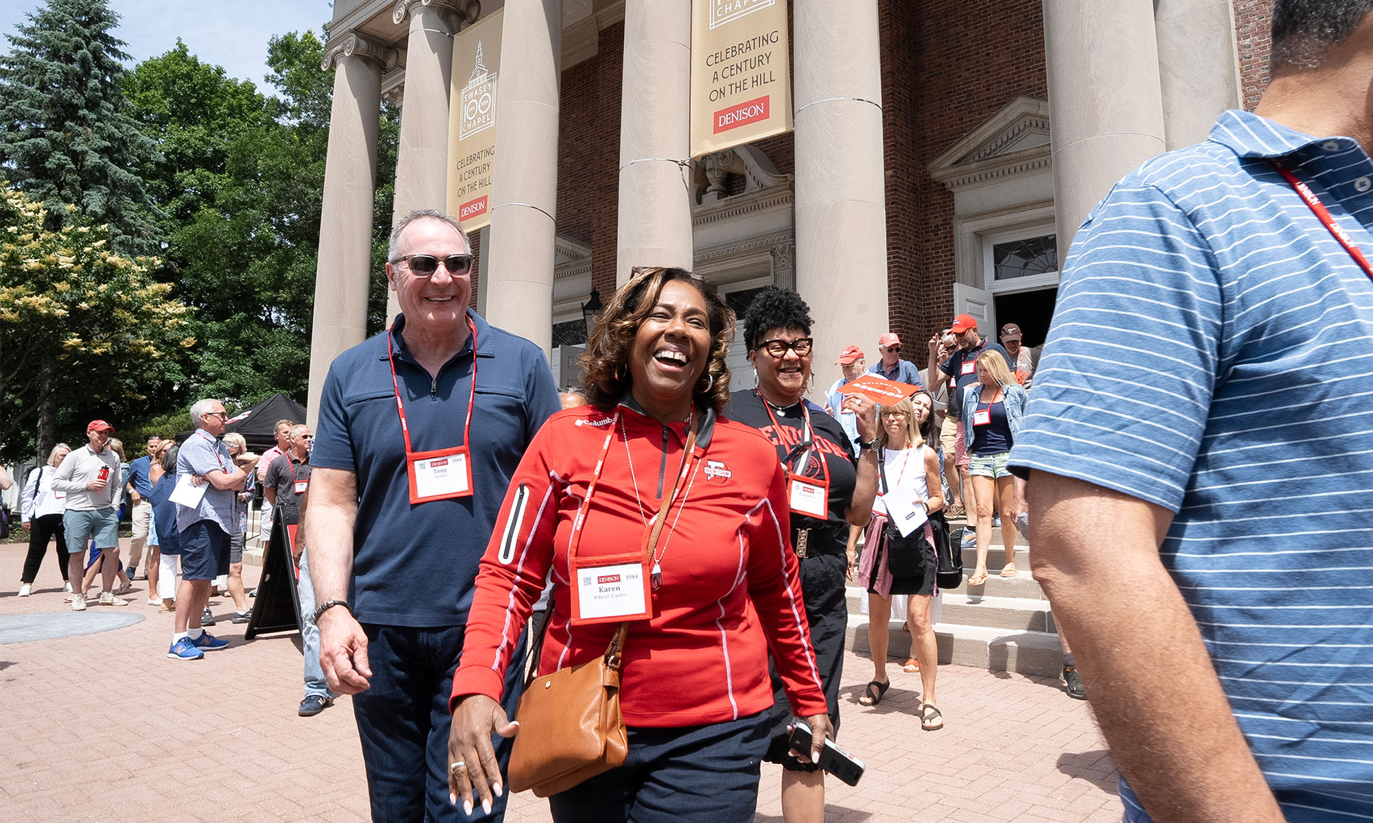 People smiling as they leave Swasey Chapel