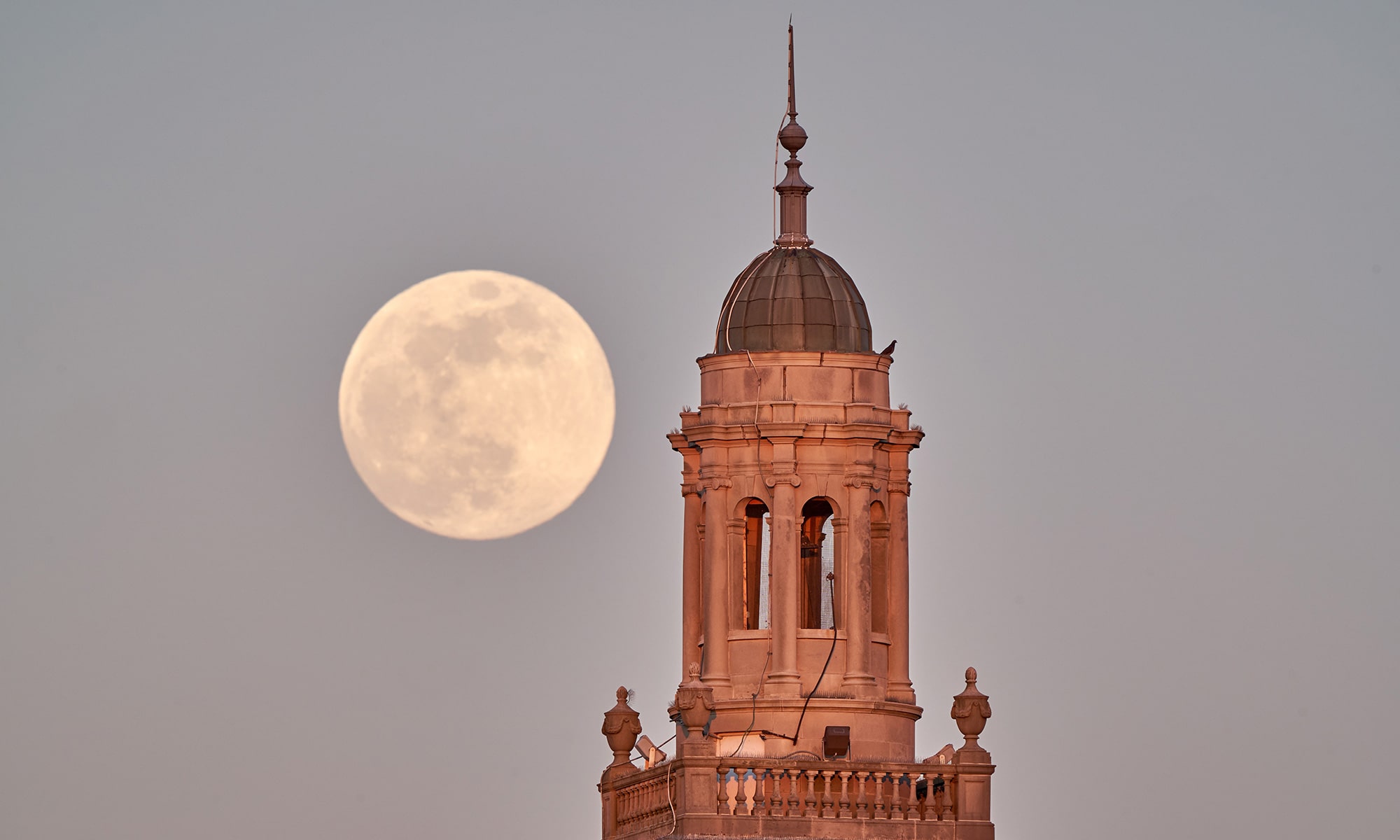 Top of Swasey Chapel with the moon in the background