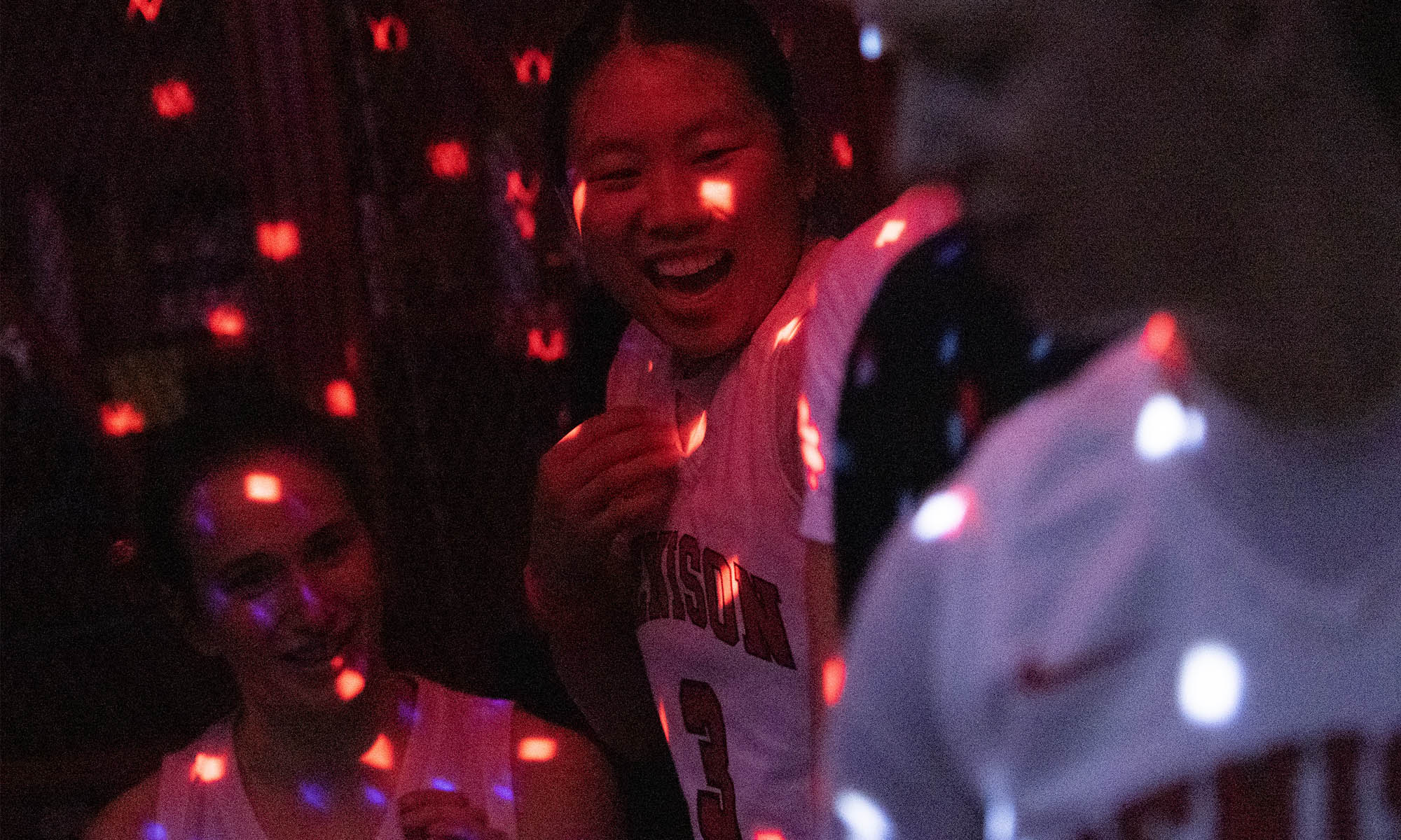 Photo of Abby Cooch (3) with teammates under the disco ball.