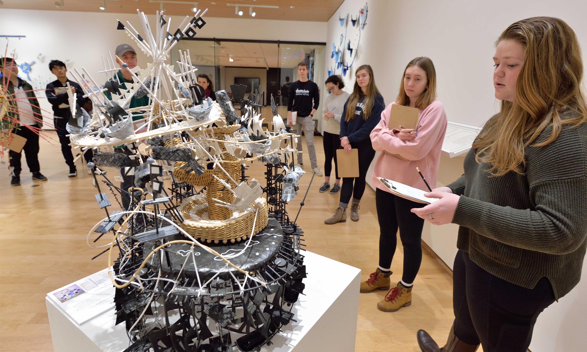 Students study sculptures at Nathalie Miebach's The Weather Variations: Connecting Data, Sculpture, and Music exhibition 