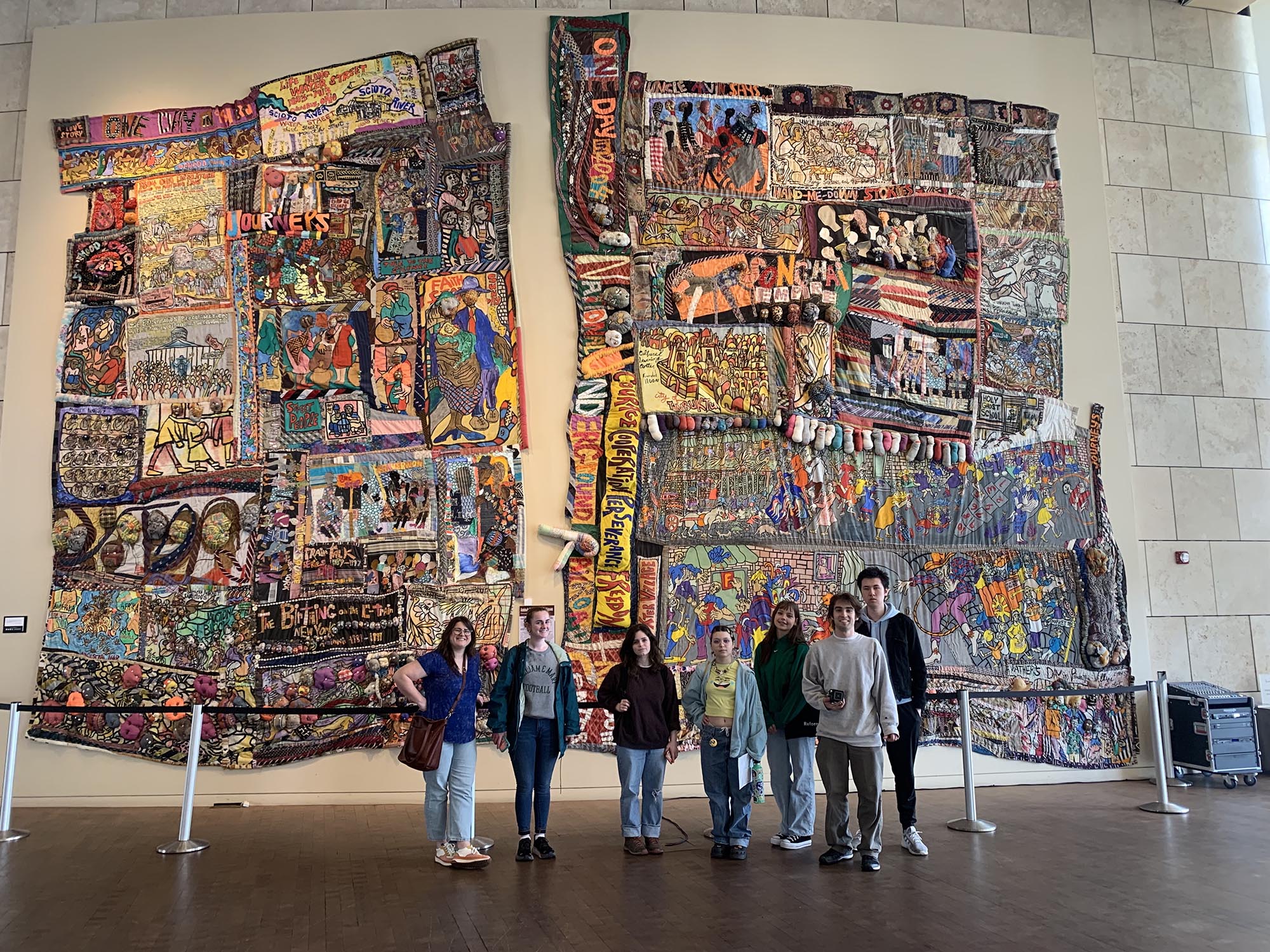 Museum interns standing in front of a large exhibit.