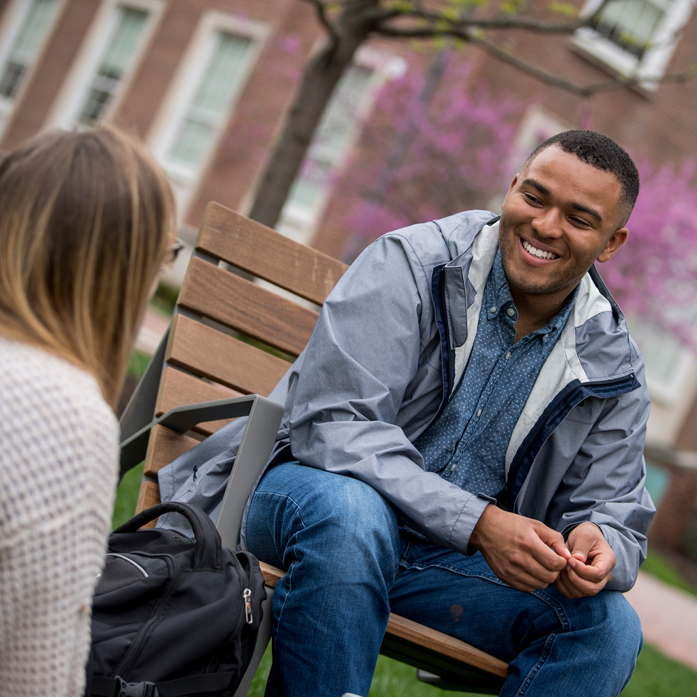 Students conversing on campus outside