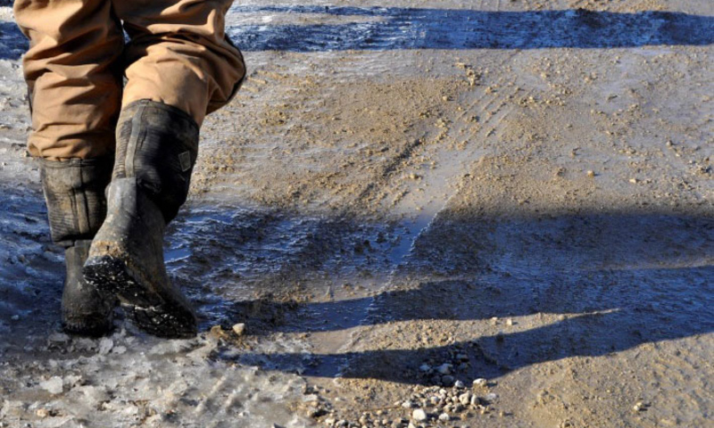 person in boots walking