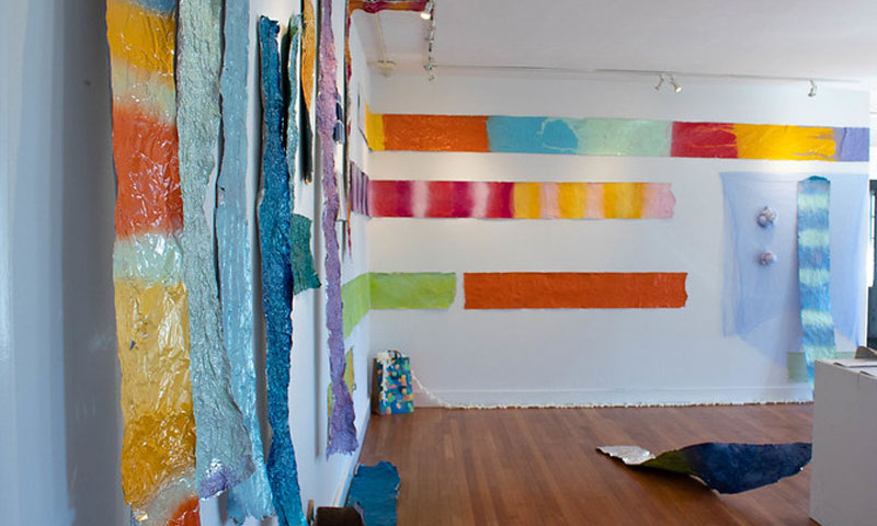 Colorful strips of Art displayed on two walls