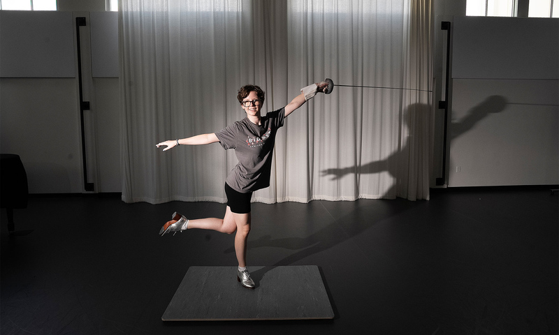 Woman posing with fencing foil