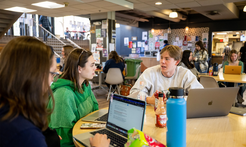 Students talking at a table in the student union