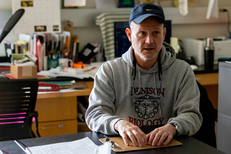 Professor Warren Hauk sitting at his desk.