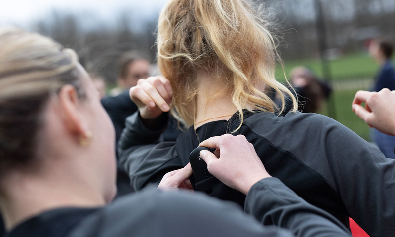 A student helping another attach the device