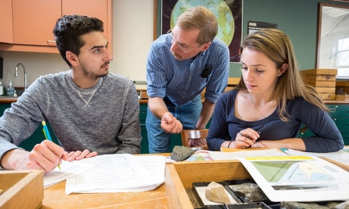 Professor with students studying