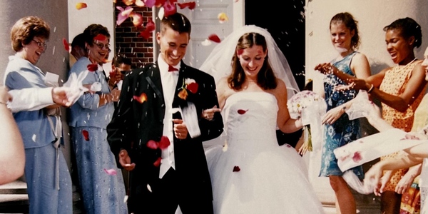 Andy and Hannah Boyd exiting Swasey Chapel on the wedding day, showered in flower petals.