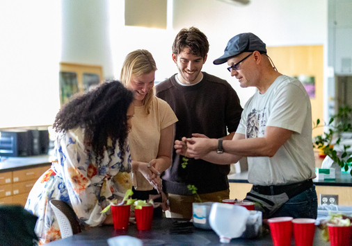 Photo of Hauk speaking with some of his teaching assistants