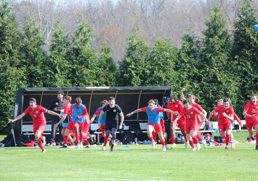 Members of the men’s soccer team run off the bench to celebrate a conference tournament championship. (Shannon O’Brien)