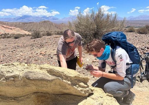 Students observing a rock