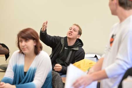 student at desk answering question