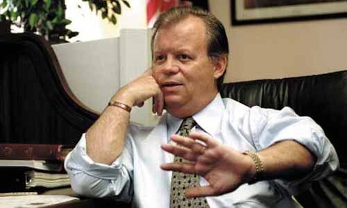 Tony Hall sitting at a desk