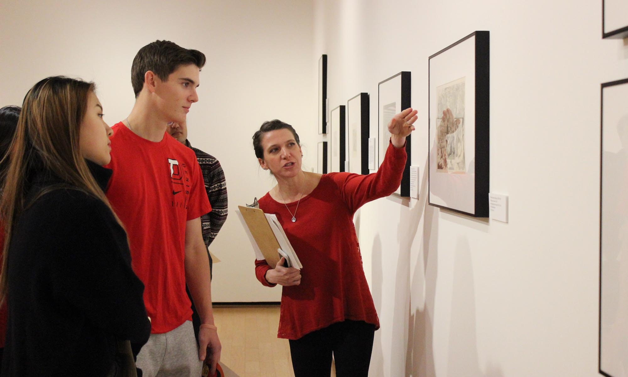 Museum staff lead a student tour of an exhibition.