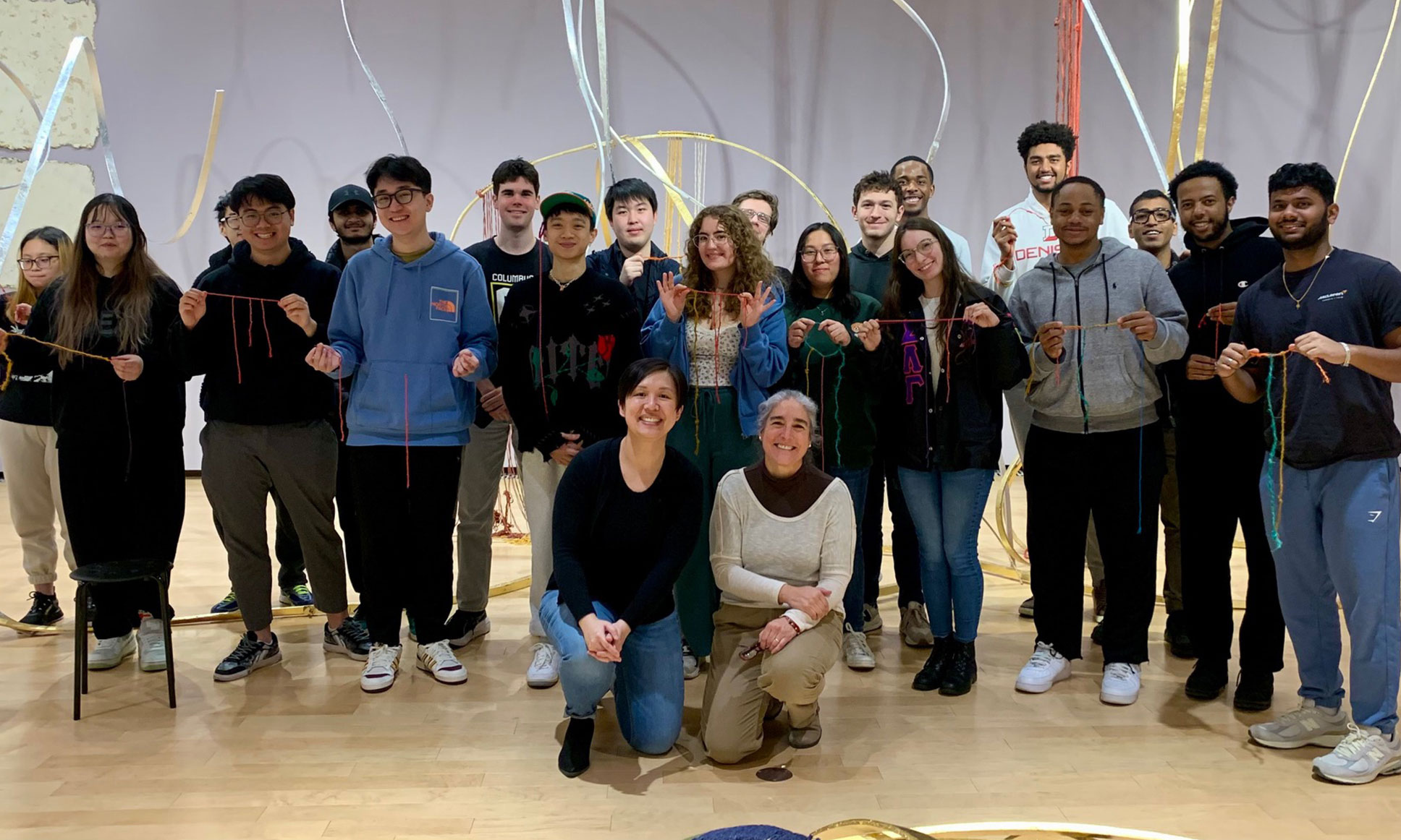 A group of students and faculty posting after a class activity at the Museum