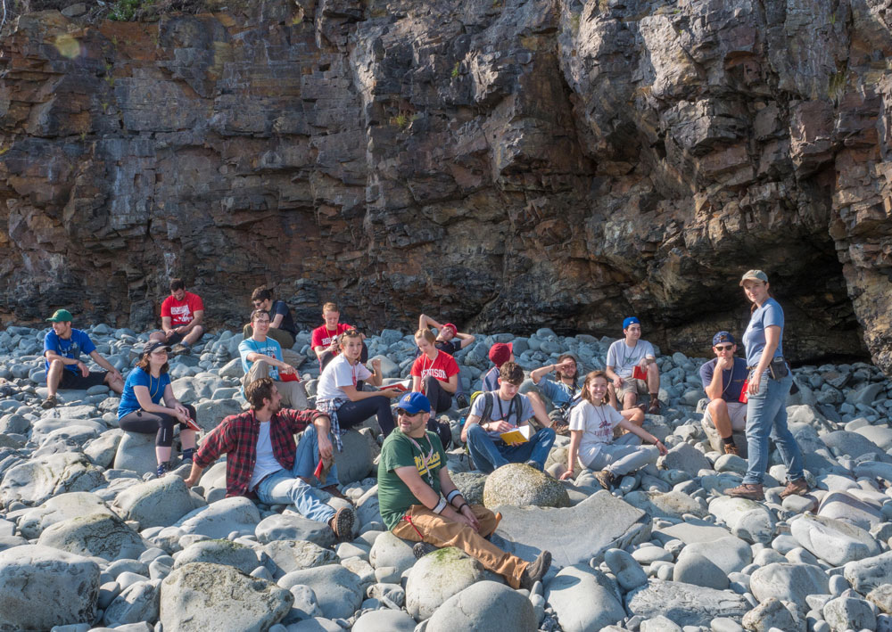 Group of students sitting on the rocks