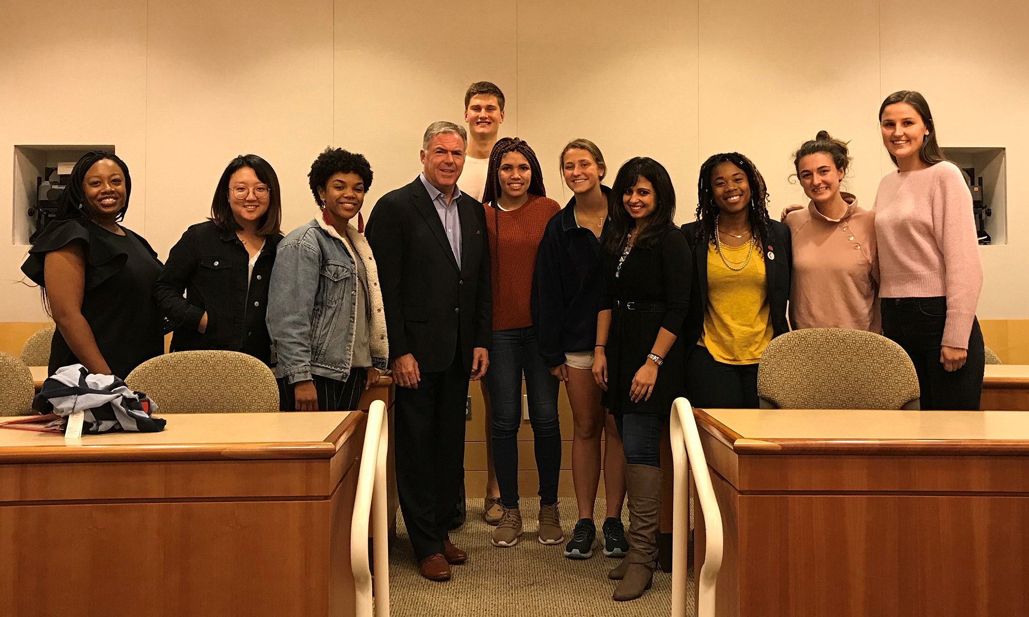 Matthew Harrington '84 and Monisha Mukhija '11 with students