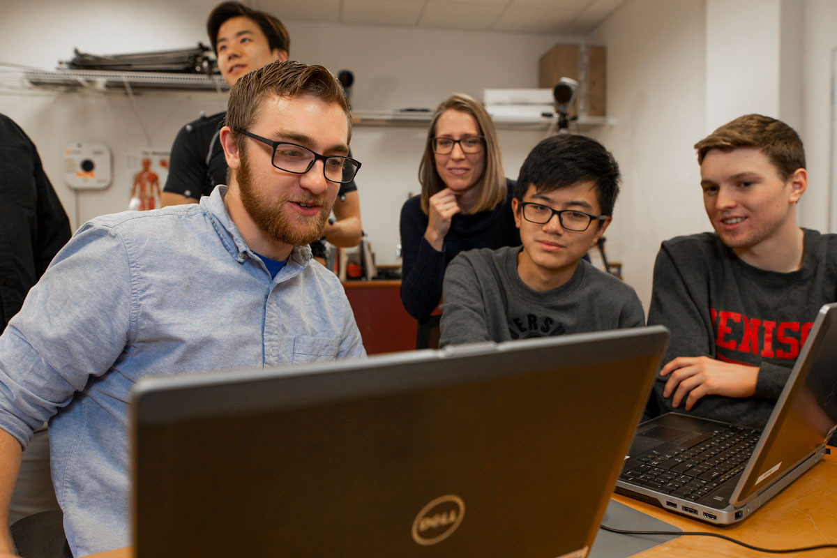 Students looking at data with a professor