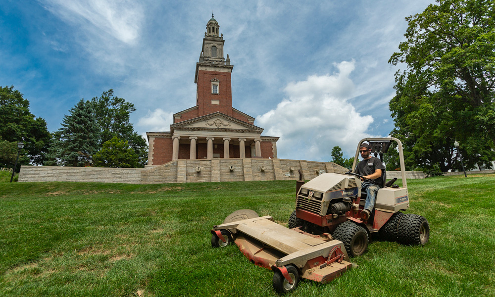 Denison's grounds crew maintaining landscape near Swasey Chapel