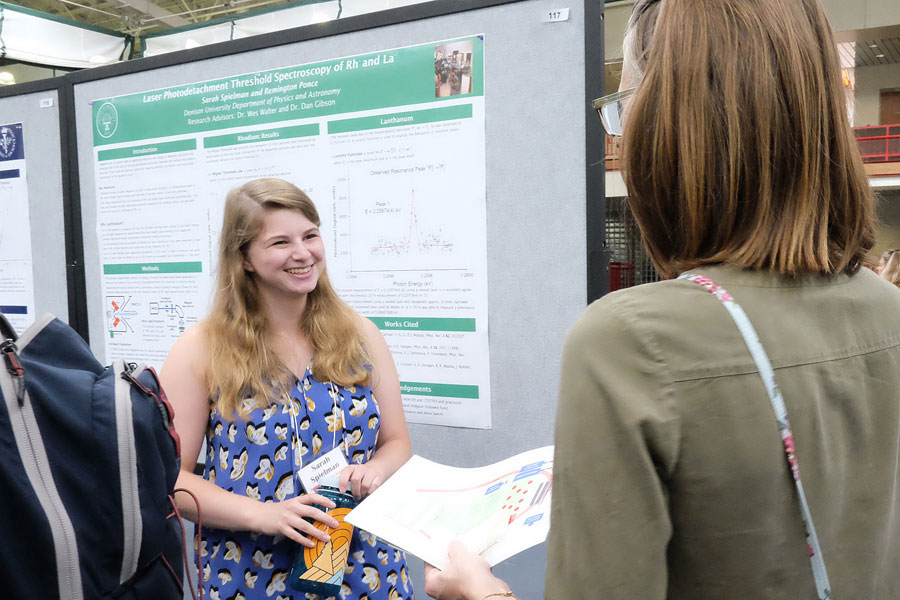 Student presenting her research to woman