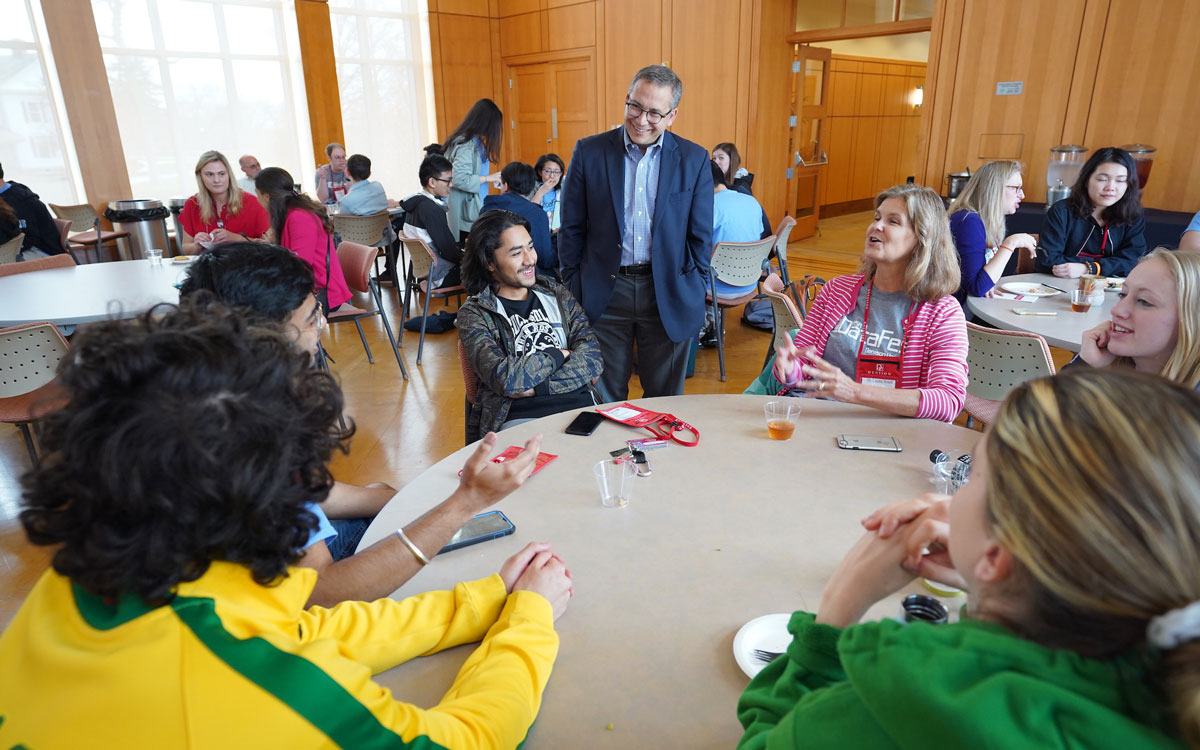 Weinberg with students at table