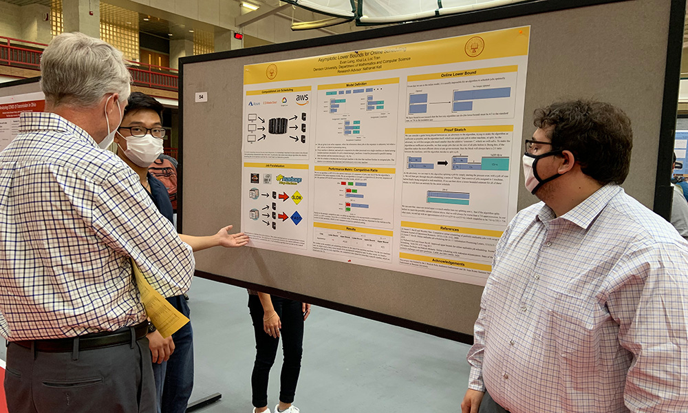 Students presenting their summer research poster