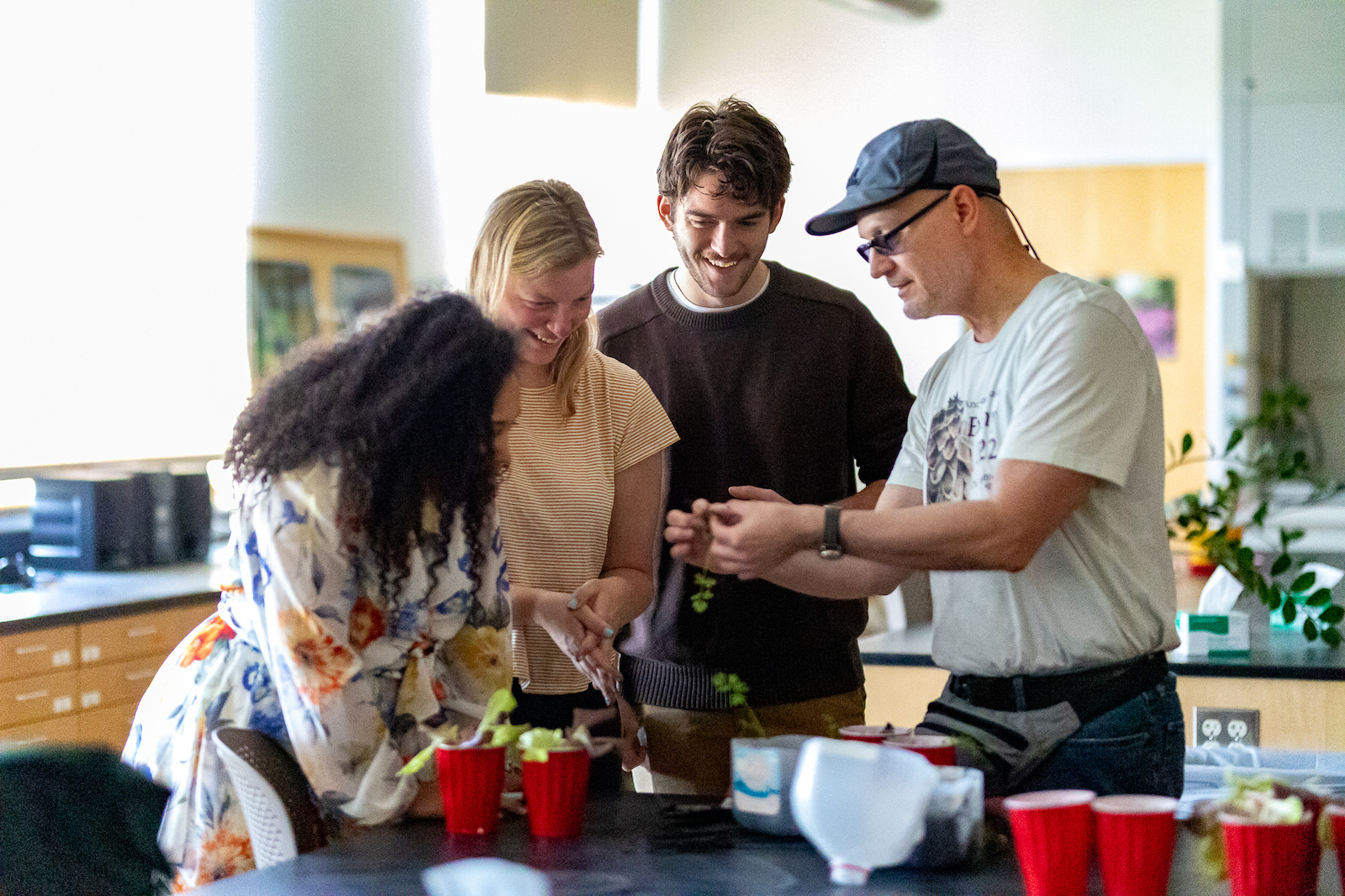 Photo of Hauk speaking with some of his teaching assistants