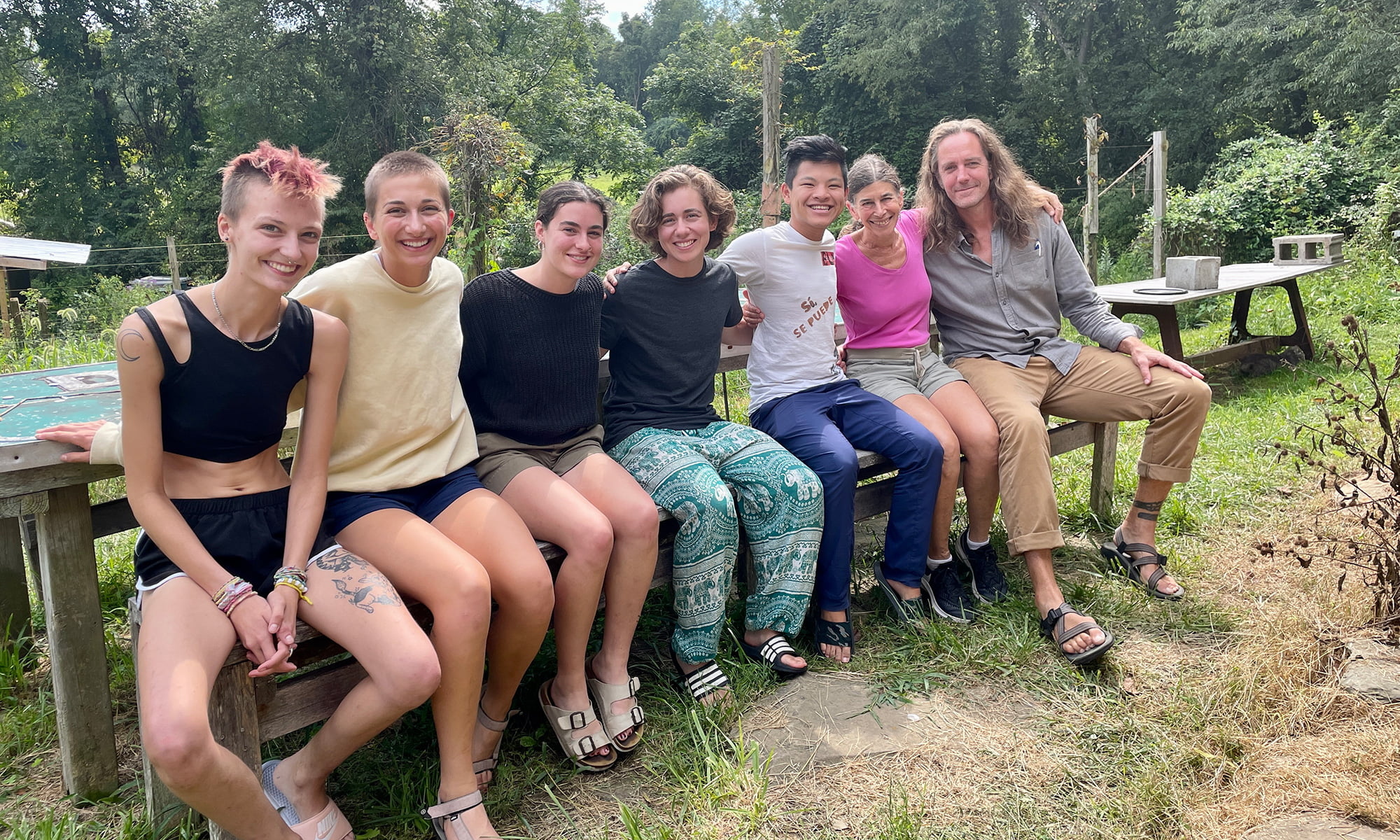 A group of people sitting outside at the homestead