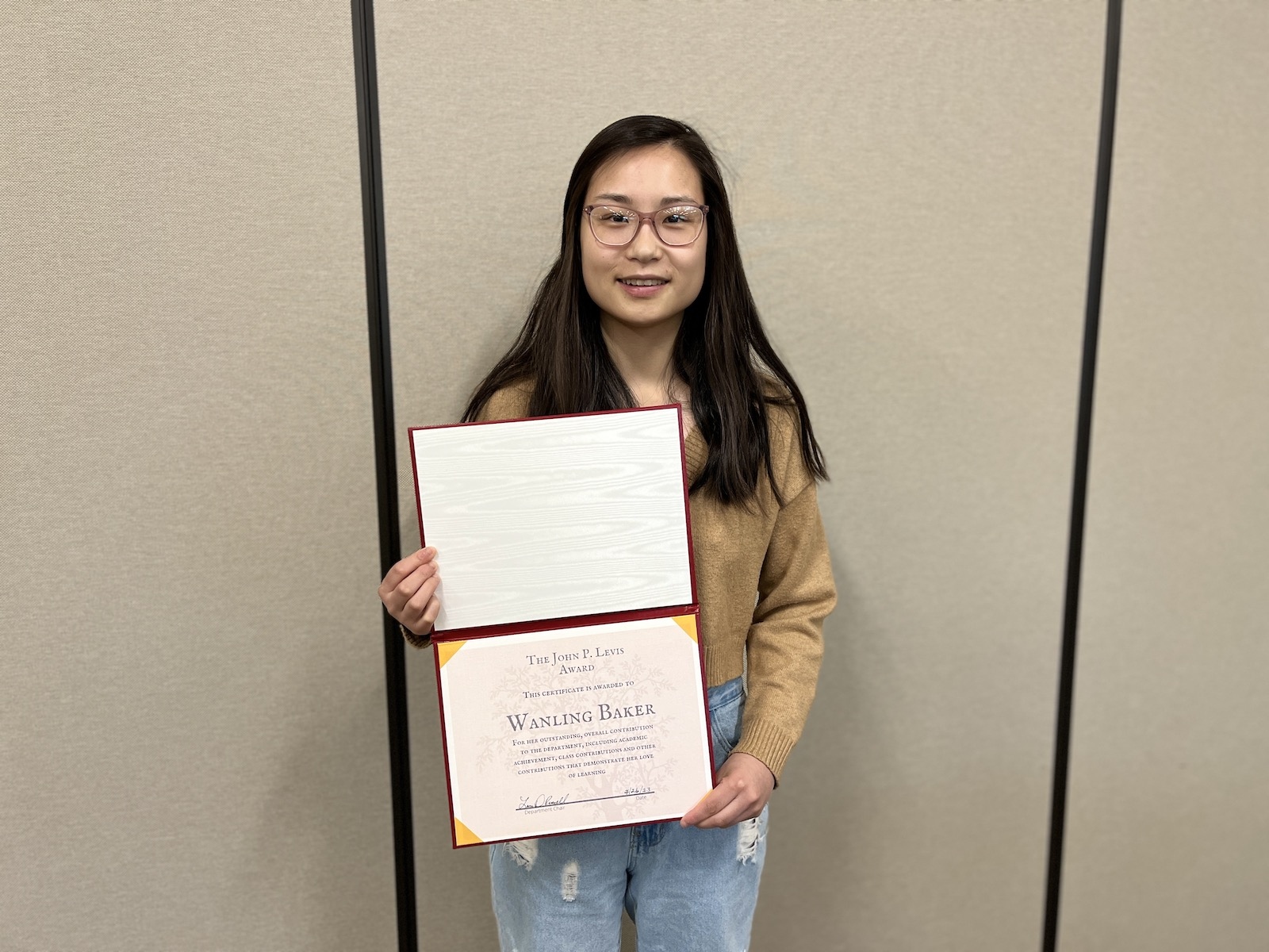 Wanling Baker holding her award