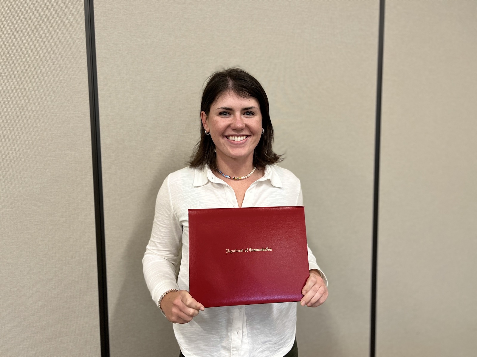 Student holding her award